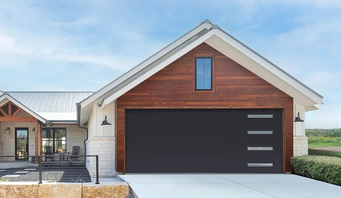 Black flush-panel garage door with full-view side windows on a modern garage.